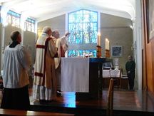 Priests and servers at the altar during an Ordinariate Mass. They face liturgical East.