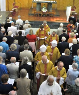 Priests and Bishop Richard process out of St Richard's through a full congregation, singing